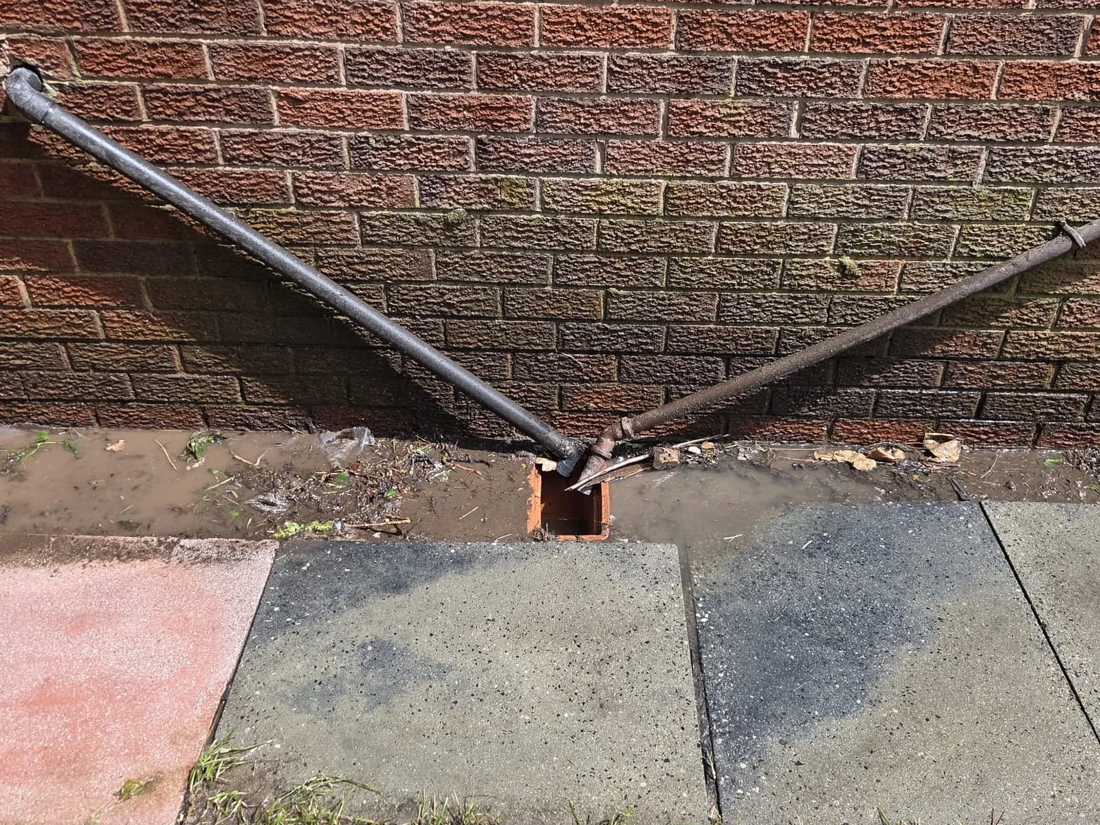 Wall and drainage area after OCD Services cleaning