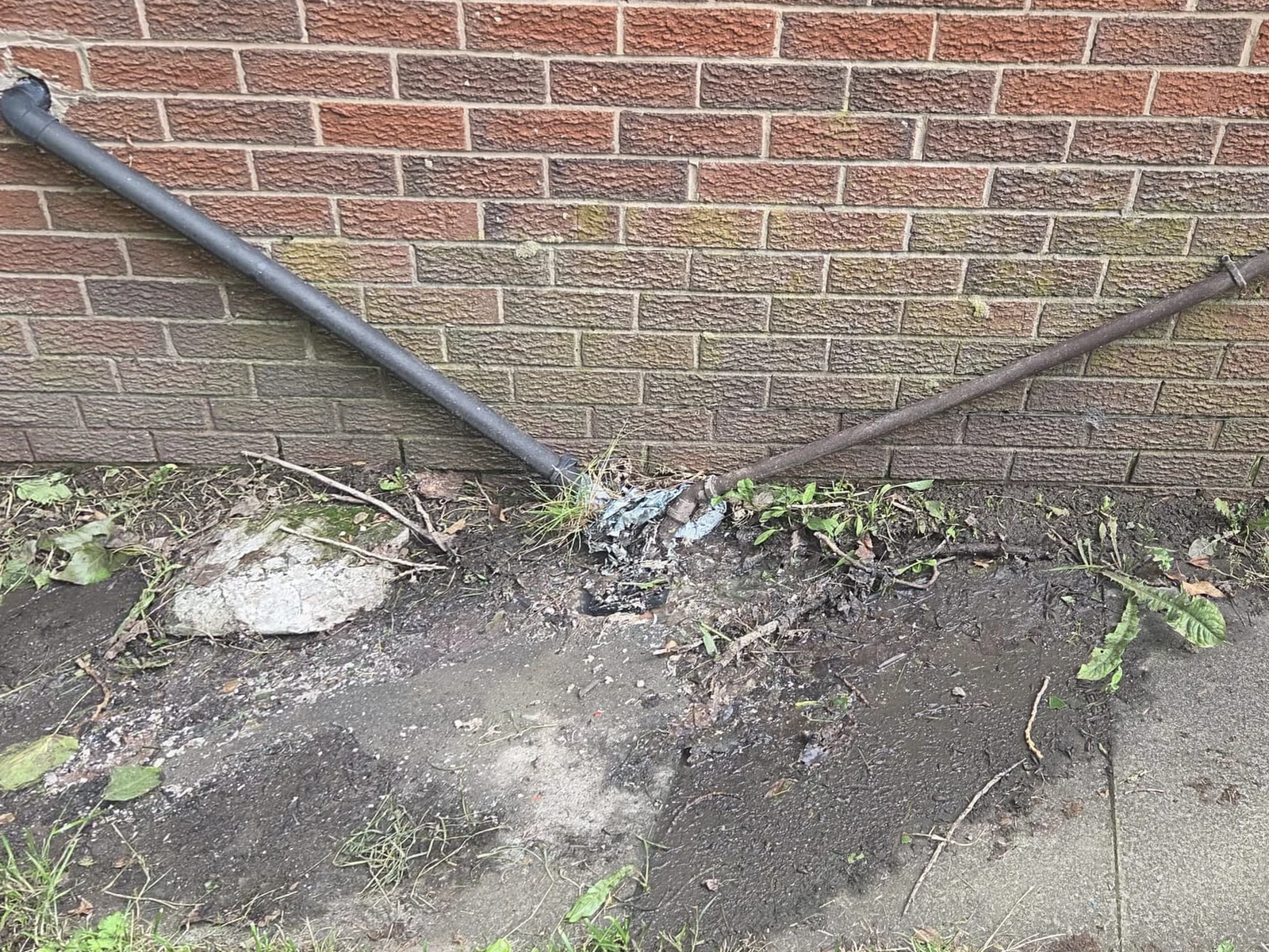 Wall and drainage area before OCD Services cleaning